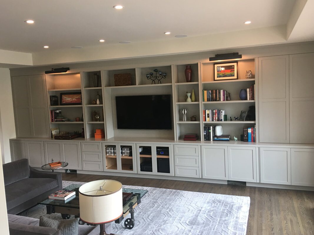 Full-wall living room cabinetry and open shelving
