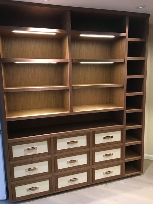 Custom walk-in closet with integrated lighting and drawers