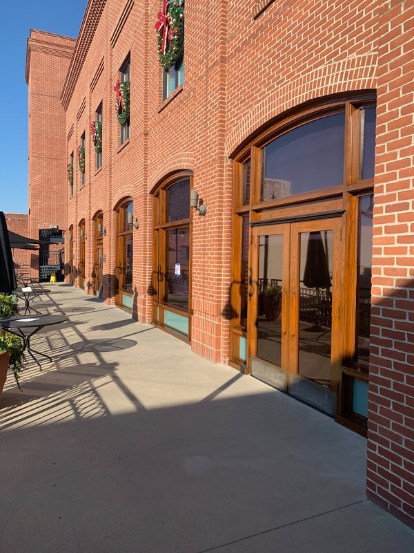 Custom wood doors and arched storefront windows